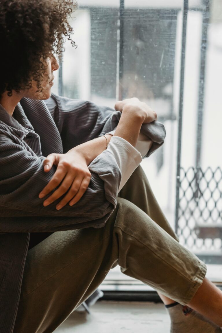 Image of lady staring outside through a window